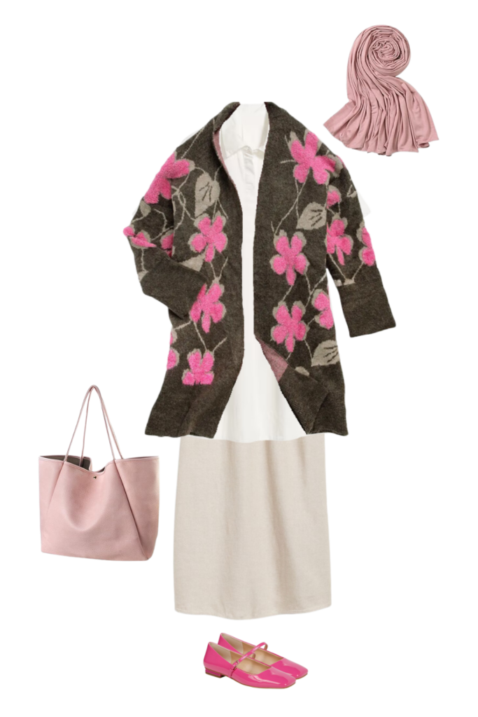 An elegant modest outfit featuring a white collared tunic, a beige long underskirt, and a soft pink scarf for a chic layered look. The ensemble is complemented by a cozy dark brown cardigan with vibrant pink floral accents, a blush pink tote bag, and bold pink Mary Jane flats for a touch of playful sophistication.