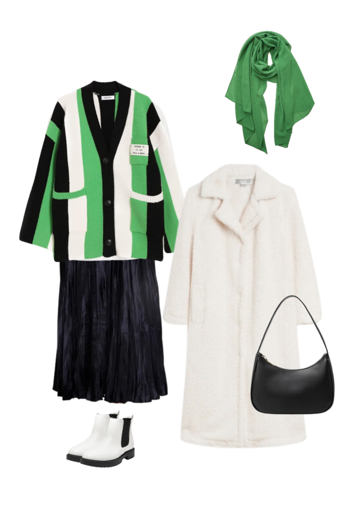 A stylish modest winter outfit featuring a bold green and black striped cardigan layered over a classic white shirt. The look includes a navy pleated midi skirt, a cozy white teddy coat, a vibrant green scarf, a sleek black shoulder bag, and white Chelsea boots with black detailing. Perfect for adding a pop of color and texture to your cold-weather wardrobe.